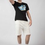Young guy posing wearing the Black Baller Boys Dunk Tee t-shirt and Baseline shorts in Ecru