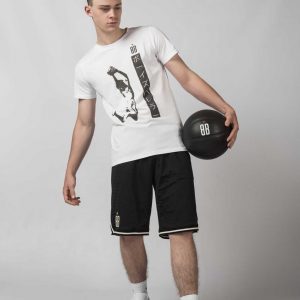 Young Guy walking wearing a white Baller Boys Basukettoboru Tee, black Big Ballin shorts and white Nike Sneakers
